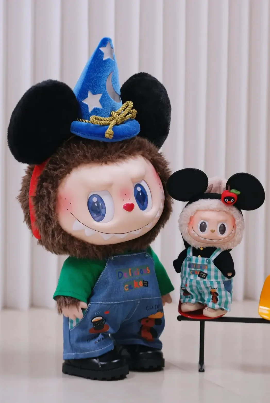 Labubu plush dolls with Mickey-style hats in colorful outfits, displayed indoors